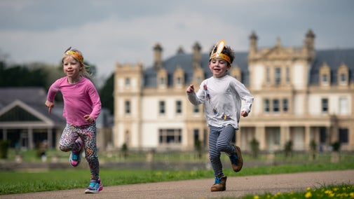 Two children running along the Easter trail at Dyffryn Gardens, Vale of Glamorgan